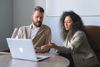 Image of corporate employees reading a newsletter on a laptop.